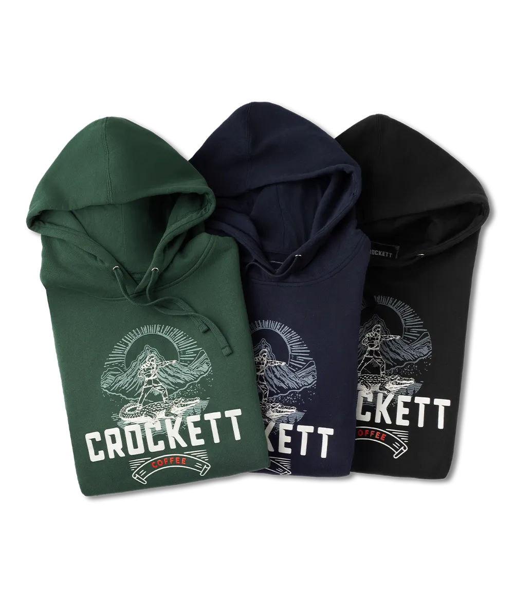 Hoodies in green, navy blue, and black featuring Crockett Coffee logo and mountain graphic printed on the front.
