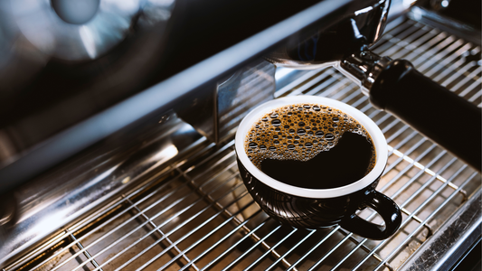 Americano in a mug on an espresso machine.