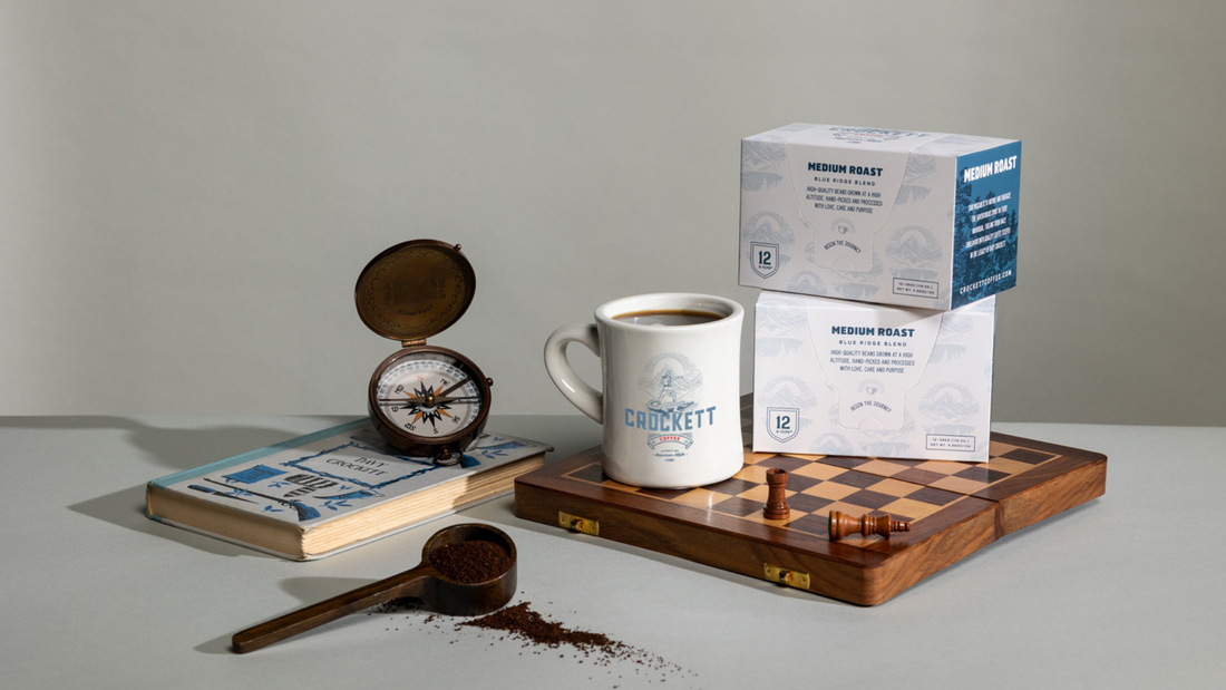 K-Cup coffee in packaging on a chessboard with a full mug of coffee.