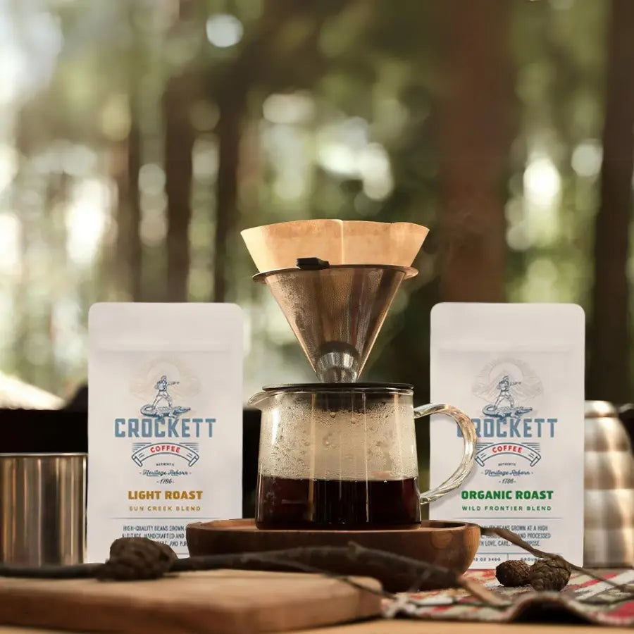 Organic coffee brewed outdoors using a pour-over method, with Crockett Coffee light and medium roast bags in the background