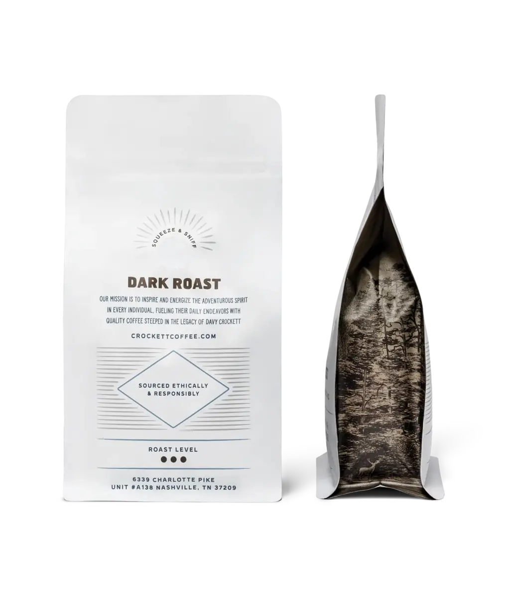 Dark roast coffee bag from Crockett Coffee, featuring ethically sourced details and a forest-inspired design inside the packaging.