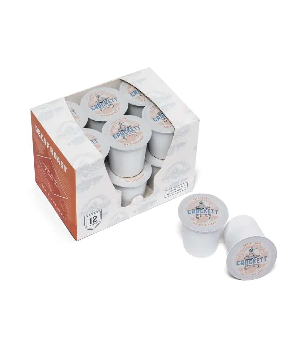 Decaf coffee K Cups from Crockett Coffee in a 12-pack box with two pods displayed outside.
