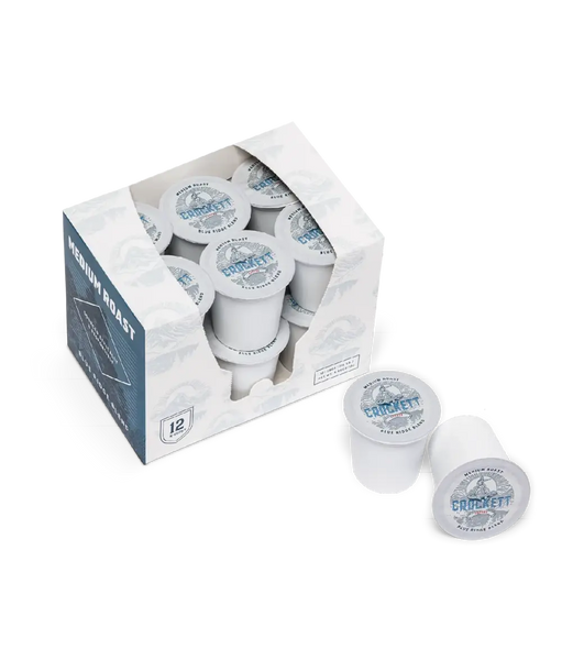 Medium roast coffee pods in a box labeled “Crockett Coffee Blue Ridge Blend,” with two pods displayed outside the packaging.