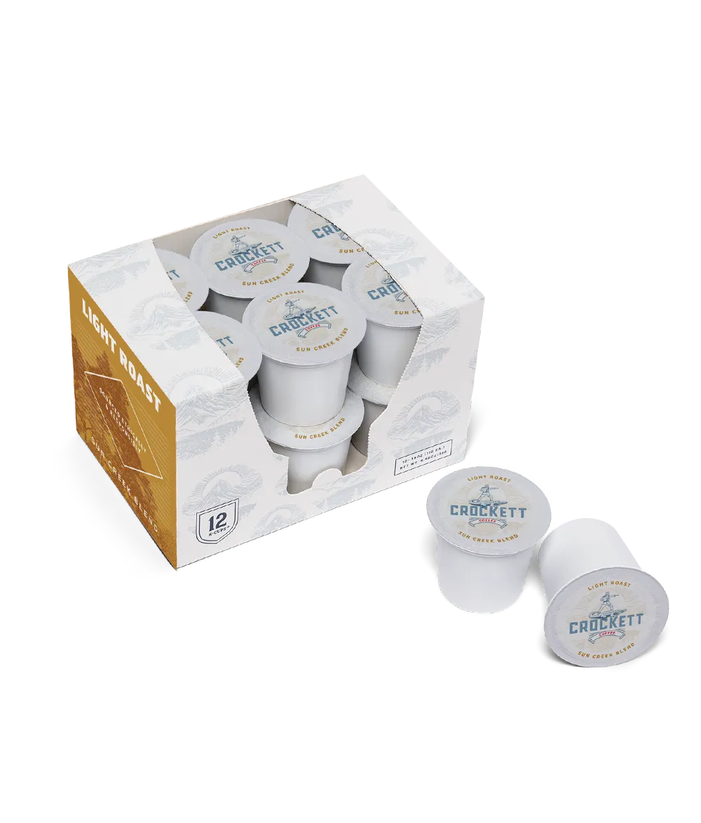 Subscription coffee K-Cups in a Crockett Coffee light roast box with pods displayed outside.