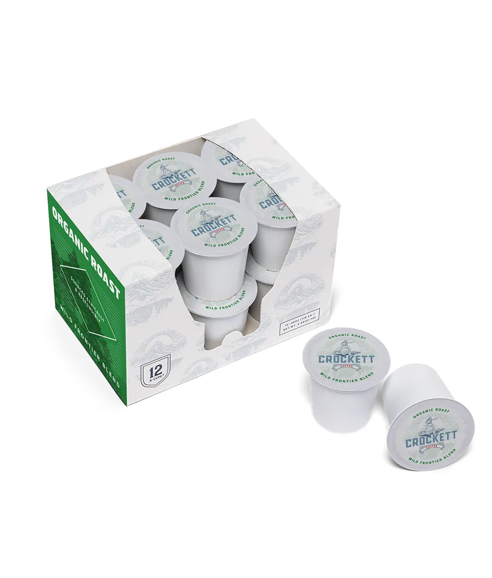 Organic roast coffee pods in a green and white box with two Crockett-branded pods displayed outside the packaging.