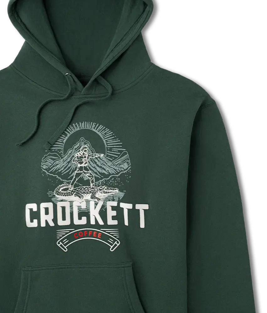 Dark green hoodie with drawstrings and front pocket featuring a Crockett Coffee logo and mountain scene graphic on the chest.