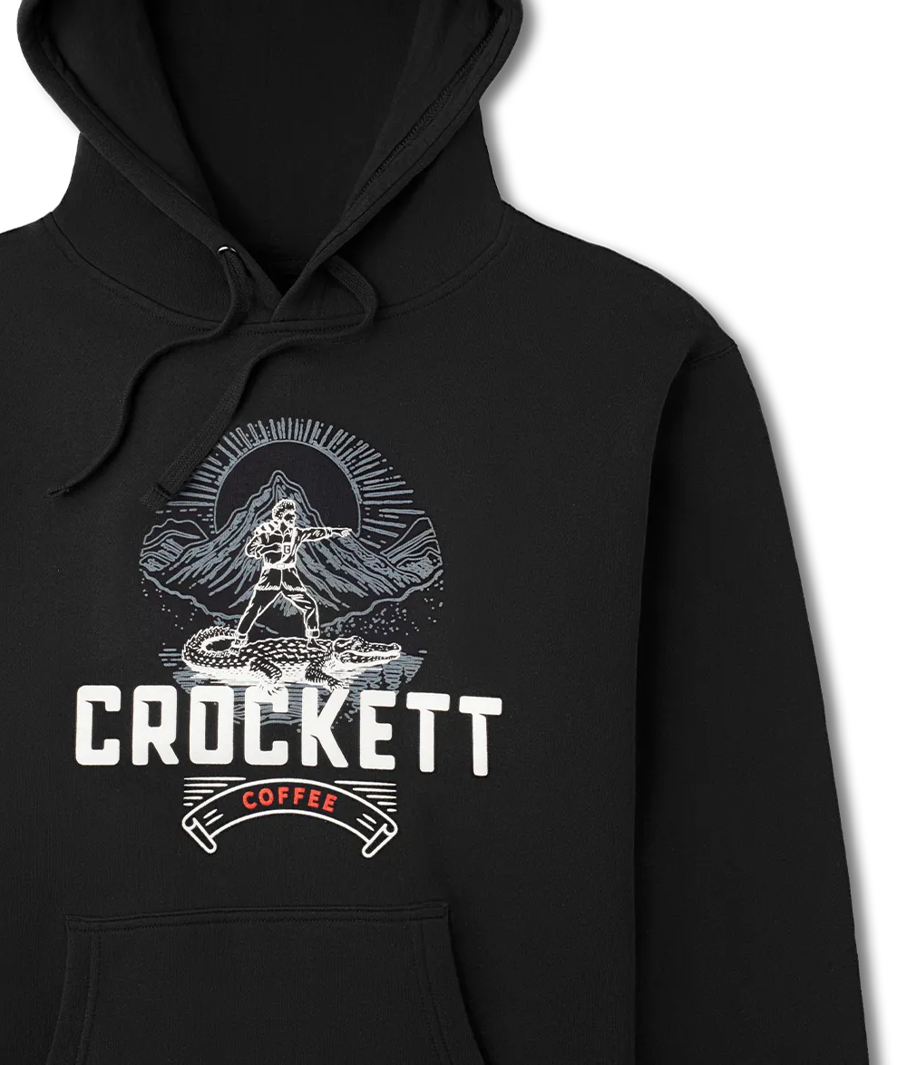 Black hoodie with drawstrings and front pocket featuring a bold Crockett Coffee logo and mountain scene graphic on the chest.