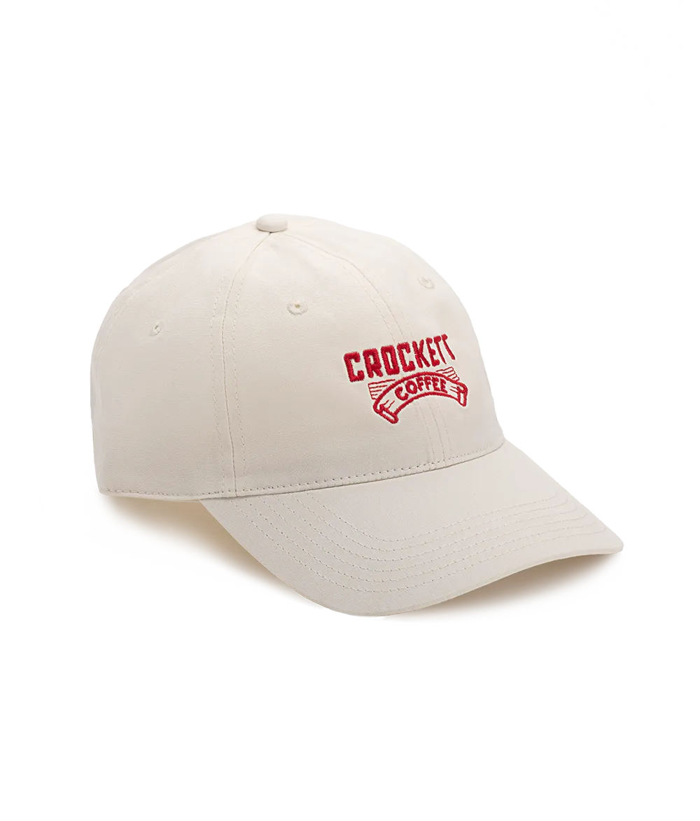 Cotton cap in cream color with red embroidered Crockett Coffee logo on the front.