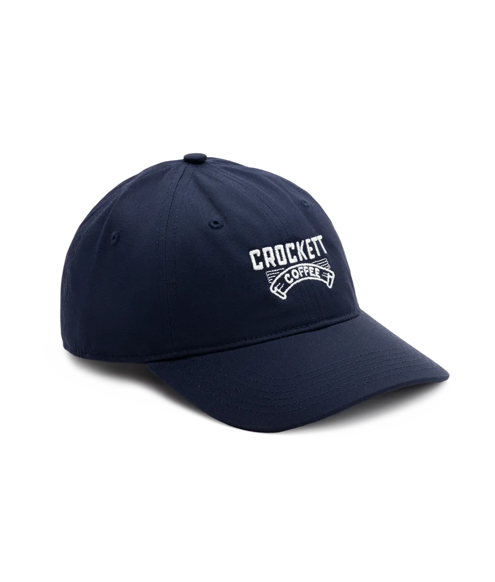Cotton cap in navy blue featuring white embroidered Crockett Coffee logo on the front.