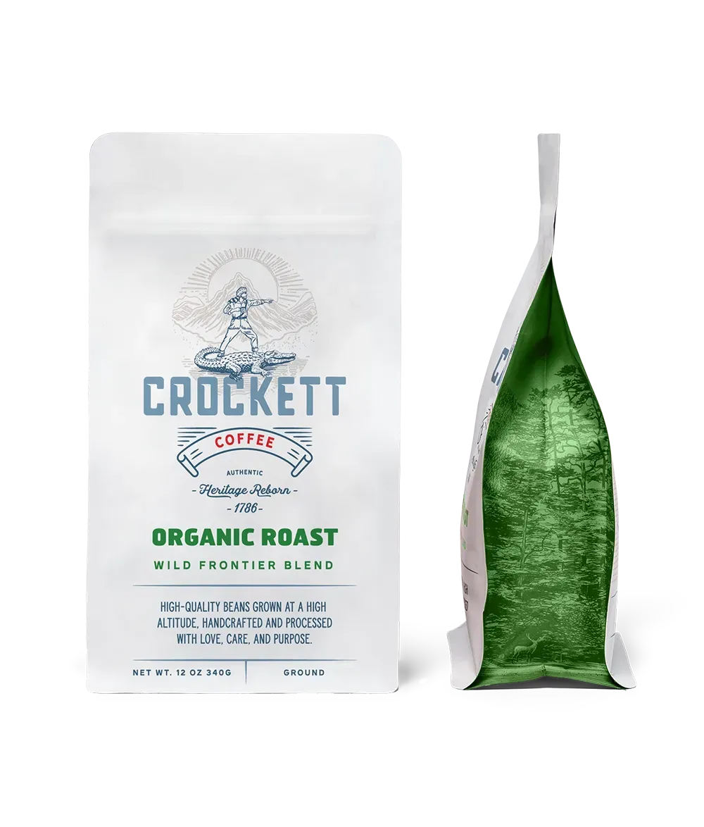 Organic coffee packaging of Crockett Coffee's "Organic Roast Wild Frontier Blend" with a white and green design for ground coffee.