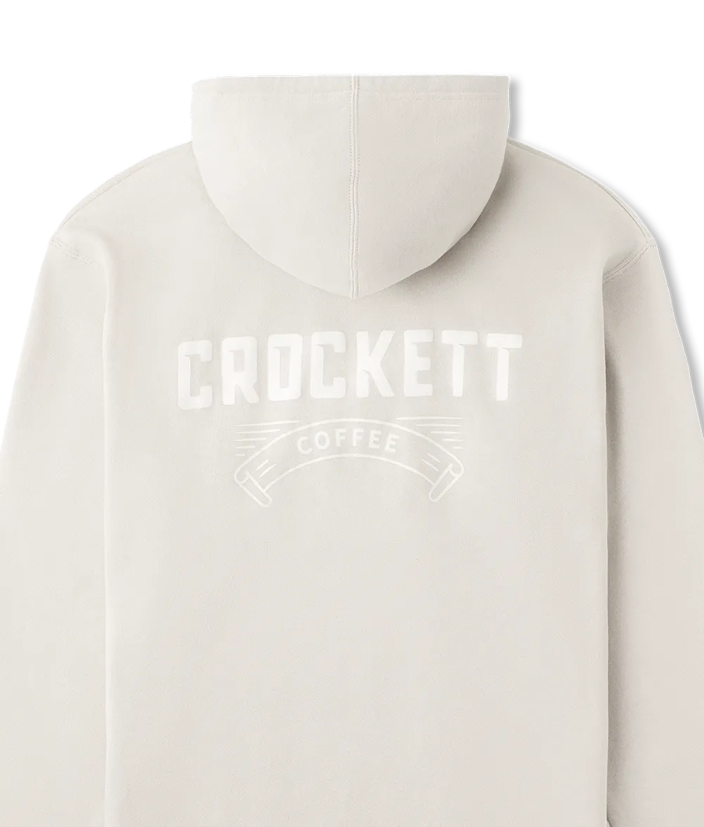 White hoodie featuring a large white Crockett Coffee logo printed across the upper back.