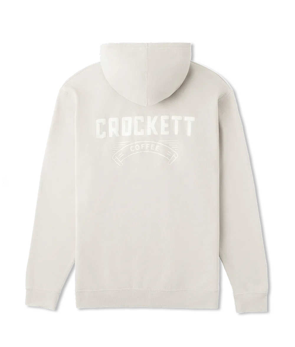 Hoodie in off-white featuring large white Crockett Coffee logo printed across the back.