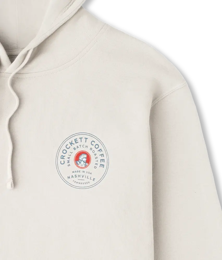 White hoodie with drawstrings and a circular Crockett Coffee logo that reads “Small Batch Roasted” and “Nashville, Tennessee.”